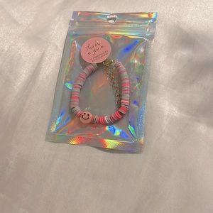 Gray and pink clay bead bracelet with pink charm